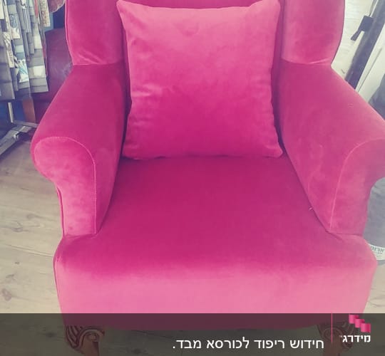 כורסה ורודה עם כרית תואמת על מושב עץ